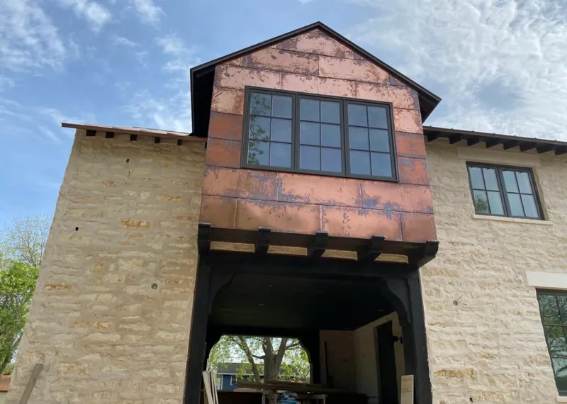 Copper metal panel facade on a stone building for Roof Repair in Collegeville